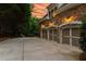 Three-car garage with stone accents and driveway, providing ample parking and enhancing curb appeal at 7025 Kettering Ln, Suwanee, GA 30024