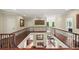 Elegant hallway with hardwood floors, iron railings, and views into the living spaces below at 7025 Kettering Ln, Suwanee, GA 30024