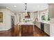Open kitchen with an island, stainless appliances, and custom cabinetry at 7025 Kettering Ln, Suwanee, GA 30024