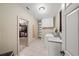 Well-lit laundry room featuring a utility sink, washer, dryer, and storage cabinets, conveniently located near closet at 7025 Kettering Ln, Suwanee, GA 30024