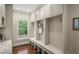 Mudroom area with hooks and storage for coats and shoes with a window at 7025 Kettering Ln, Suwanee, GA 30024