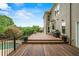 Expansive outdoor deck boasts wood flooring, a built-in grill, and a scenic view of the landscaped backyard at 7025 Kettering Ln, Suwanee, GA 30024