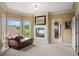 Bright sitting room features a fireplace and a cozy chaise lounge at 7025 Kettering Ln, Suwanee, GA 30024