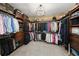 Spacious walk-in closet with custom shelving, drawers, and ample storage space for clothes and accessories at 7025 Kettering Ln, Suwanee, GA 30024