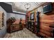 Wine cellar with wood paneling, stone floors, wine rack, and wood cabinet at 7025 Kettering Ln, Suwanee, GA 30024