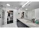 Bright bathroom with double sinks, granite countertops, and a glass-enclosed shower at 860 Peachtree Ne St # 1502, Atlanta, GA 30308