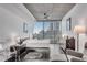 Bright bedroom featuring city views, modern decor, and wood floors at 860 Peachtree Ne St # 1502, Atlanta, GA 30308