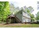 Backyard view of the home and elevated deck featuring a staircase for convenient access to outdoor living at 1737 Mount Berry Dr, Douglasville, GA 30135