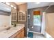 Bathroom featuring a granite-topped vanity, tub, and neutral decor at 1737 Mount Berry Dr, Douglasville, GA 30135