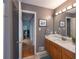 Bathroom with marble vanity, neutral walls, and open doorway at 1737 Mount Berry Dr, Douglasville, GA 30135