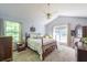 Comfortable bedroom with vaulted ceilings, carpet, and plenty of natural light at 1737 Mount Berry Dr, Douglasville, GA 30135