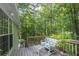 This backyard deck offers peaceful outdoor seating surrounded by a lush, green wooded area at 1737 Mount Berry Dr, Douglasville, GA 30135