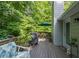 Inviting backyard deck features outdoor seating, a grill, and lush greenery for relaxing and entertaining at 1737 Mount Berry Dr, Douglasville, GA 30135