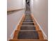 Carpeted staircase enhances safety and elegance with a wooden handrail at 1737 Mount Berry Dr, Douglasville, GA 30135