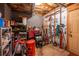 Unfinished basement storage area has a variety of tools, lawn equipment, and shelving for optimal organization at 1737 Mount Berry Dr, Douglasville, GA 30135
