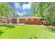 Expansive backyard featuring a brick exterior, a covered patio, and a lush lawn, perfect for outdoor activities and relaxation at 3170 Bellgreen Way, Decatur, GA 30032