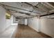 Unfinished basement with exposed ceiling, window and white painted walls awaiting customization and offers extra storage or living space at 3170 Bellgreen Way, Decatur, GA 30032