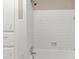 All-white bathroom featuring tile, bathtub, and cabinets at 3170 Bellgreen Way, Decatur, GA 30032