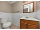 Bathroom featuring a toilet, white tiled walls, and a wooden vanity with sink at 3170 Bellgreen Way, Decatur, GA 30032