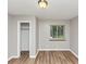Bedroom with wood-look floors, closet, and a window at 3170 Bellgreen Way, Decatur, GA 30032