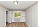 Bedroom with built-in shelves, wainscoting, and wood-look flooring at 3170 Bellgreen Way, Decatur, GA 30032