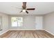 Bright living room featuring new hardwood floors, modern ceiling fan and natural light at 3170 Bellgreen Way, Decatur, GA 30032