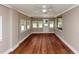 Sunroom with hardwood floors, multiple windows, and painted brick walls at 3170 Bellgreen Way, Decatur, GA 30032