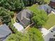 Aerial view of the home showcasing its manicured lawn, driveway, and beautiful surroundings at 4250 Old Oak Trce, Cumming, GA 30041