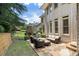 Spacious back patio with an outdoor fireplace and comfortable seating, perfect for entertaining at 4250 Old Oak Trce, Cumming, GA 30041