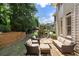 The home features a lovely stone patio with seating and a stone outdoor fireplace at 4250 Old Oak Trce, Cumming, GA 30041