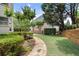 Lush backyard featuring a stone pathway and well-maintained landscaping with mature trees at 4250 Old Oak Trce, Cumming, GA 30041