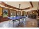 Finished basement with a bar, ping pong table, tiled floor and walkout access at 4250 Old Oak Trce, Cumming, GA 30041