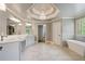 Bathroom featuring a chandelier, stand alone tub, and large tile floor at 4250 Old Oak Trce, Cumming, GA 30041