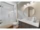 Renovated bathroom with marble countertop, gray vanity, tile shower, and updated fixtures at 4250 Old Oak Trce, Cumming, GA 30041