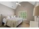Cozy bedroom with vaulted ceiling, ceiling fan, large window, and neutral decor at 4250 Old Oak Trce, Cumming, GA 30041