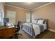 Cozy bedroom with neutral colors, a metal frame bed, and natural light at 4250 Old Oak Trce, Cumming, GA 30041