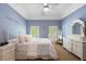 Charming bedroom with blue walls, white furniture and decor, and plenty of natural light at 4250 Old Oak Trce, Cumming, GA 30041