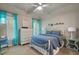 Bedroom with a blue comforter and turquoise curtains, creating a bright and inviting space at 4250 Old Oak Trce, Cumming, GA 30041