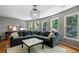 Bonus Room with hardwood floors, a large couch, accent rug, and lots of natural light at 4250 Old Oak Trce, Cumming, GA 30041