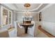 Formal dining room featuring a chandelier, large window, and seating for six at 4250 Old Oak Trce, Cumming, GA 30041