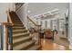 Elegant foyer with staircase, hardwood floors, and a view into the spacious living room at 4250 Old Oak Trce, Cumming, GA 30041
