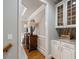 Hallway with wooden floors, built-in cabinets, lamps, and decorative molding at 4250 Old Oak Trce, Cumming, GA 30041