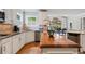 Kitchen with white cabinets, wood island, stainless steel appliances, and view of dining area at 4250 Old Oak Trce, Cumming, GA 30041