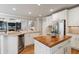 Open concept kitchen with granite counters, wine cooler, butcher block island and stainless appliances at 4250 Old Oak Trce, Cumming, GA 30041