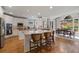 Open concept kitchen with an island, bar stools, stainless steel appliances, and a dining area at 4250 Old Oak Trce, Cumming, GA 30041