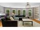 Large living room features a wall of windows and a comfortable sectional sofa for entertaining at 4250 Old Oak Trce, Cumming, GA 30041