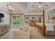 Large bedroom with wooden four poster bed, seating area, windows, and ceiling fan at 4250 Old Oak Trce, Cumming, GA 30041