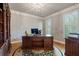 Office with a large desk, wooden floors, built-in bookcase, and natural light at 4250 Old Oak Trce, Cumming, GA 30041