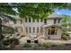View of the home's rear exterior from the back yard, showcasing the stone patio and lovely yard at 4250 Old Oak Trce, Cumming, GA 30041