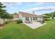 Landscaped backyard features green grass and a concrete patio with seating, offering a relaxing outdoor space at 1382 Fountain Lakes Drive Dr, Lawrenceville, GA 30043